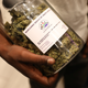 A man holds a jar full of cannabis buds at a 2018 expo in South Africa.